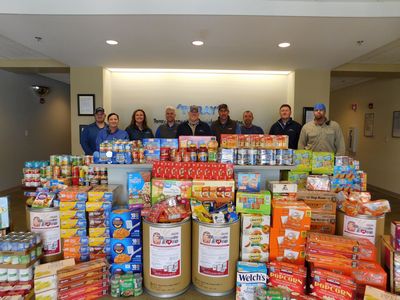 Decatur Plant employees stand behind the Barrels of Love donation items