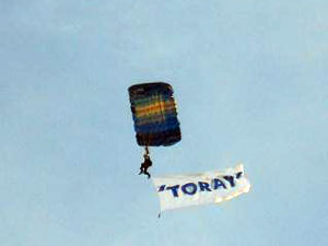 Skydiver with the Toray banner