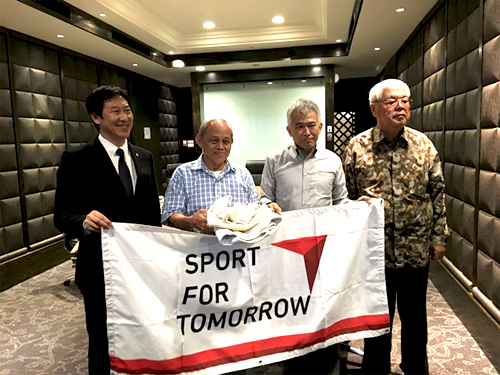 Mr. Suzuki presenting judo suits to All Indonesian Judo Federation (Mr. Suzuki far left and Kuroda far right).