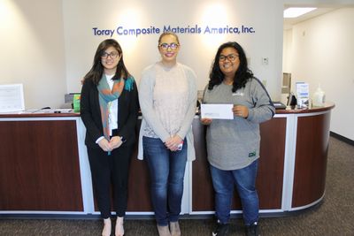 CMA Tacoma headquarters’ Janice Laureano (left) and Lanie May (right) hand CMA’s donation to the responsible person from the United Way of Pierce County, Washington