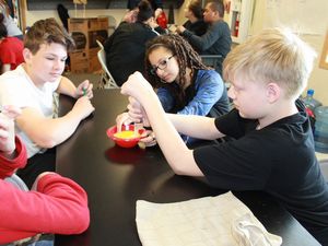 Students carry out an experiment on filtering orange juice