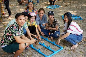 Participants help putting the coral branches onto the artificial reef