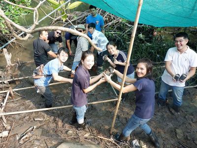 CMTH members pass soil bags from hand to hand