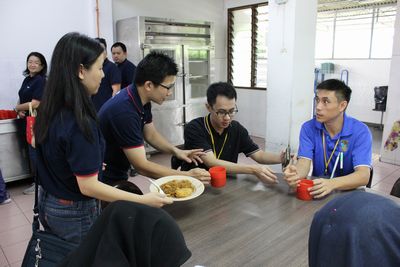 TMS staff volunteer serving refreshments