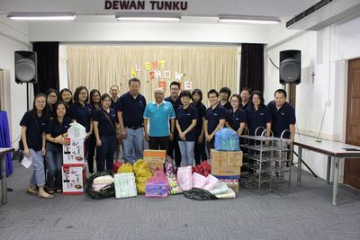 TMS staff and a St. Nicolas Home staff member with donations from us