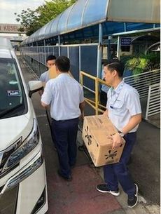 PAB staff members carry donation items PAB staff members carry donation items