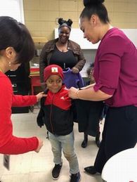 Helping one of the children from the Spartanburg Housing Authority try on their new jacket!