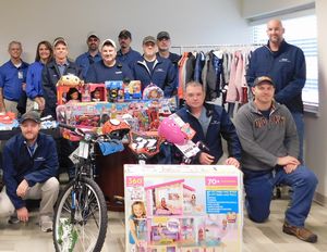 The Carbonization Maintenance crew gather around all the gifts that were donated to the seven “adopted” children from F.A.C.E.S.　