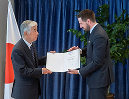 receiving the Order of Merit certificate