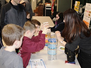 This second grade student can’t contain his excitement to work the filtration model as other third to sixth graders wait for their turns