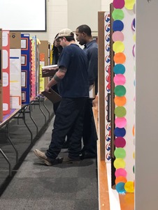 A team of CMA Spartanburg employees discuss projects during judging