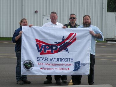 TREC employees receive the flag