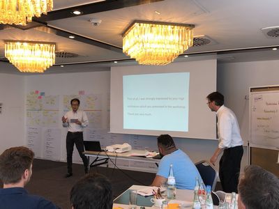 CEO Yoshiyama (left, back) thanks all participants for their contribution