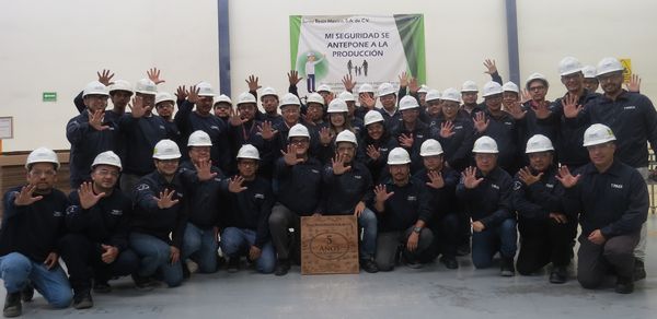 TRMX members with commemorative board of celebrating five-year accident-free record