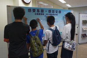 The children writing messages of encouragement for the company