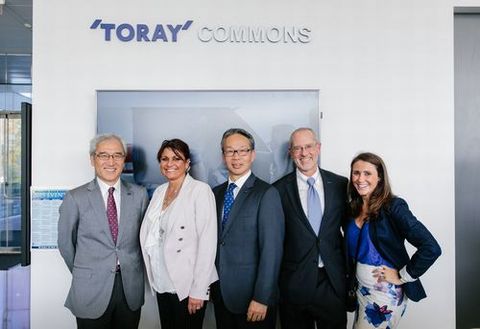 In front of the Toray kiosk inside the newly built facility. From left to right: TPA Executive Vice President Ken Kurokawa, TPA Vice President Lisa A. Ahart, Shimaji, Brandmeier, and TPA Corporate Marketing Brand Manager Mary Osso