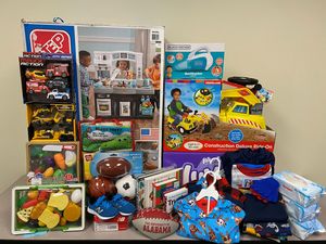 Gifts for FACES one-year old boy, including a kitchen set, ride on toy, shoes, dippers, clothes, and more
