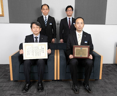 Researchers holding JCIA Technology Award certificate